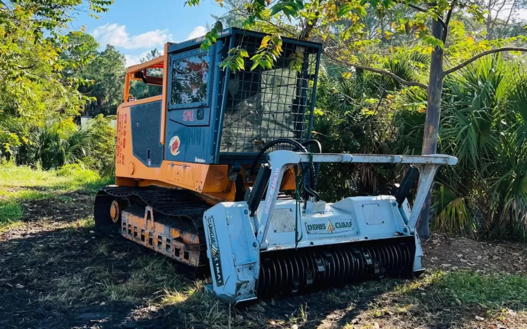 Heavy machinery clearing land with trees and debris, showcasing equipment used in land clearing operations.
